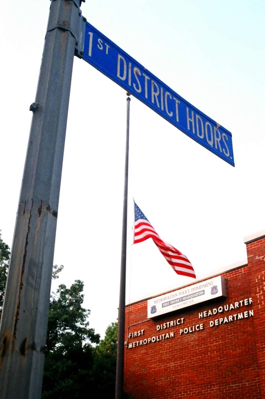 an american flag flying from the side of a pole that reads 1st district hours