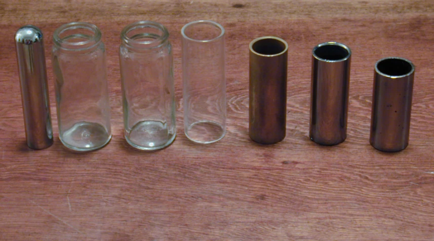 six different types of glass containers on a wooden table