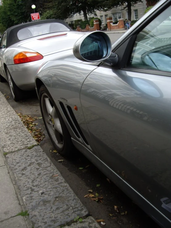 two cars parked side by side next to a street