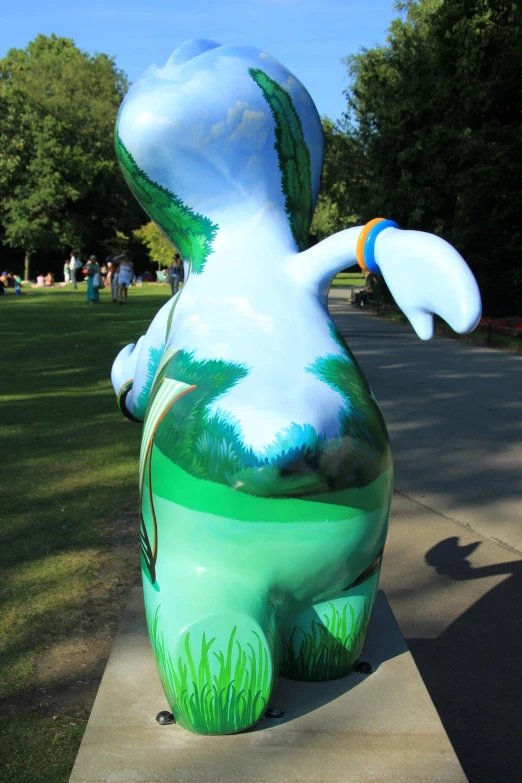 a sculpture that looks like a large dinosaur holding soing