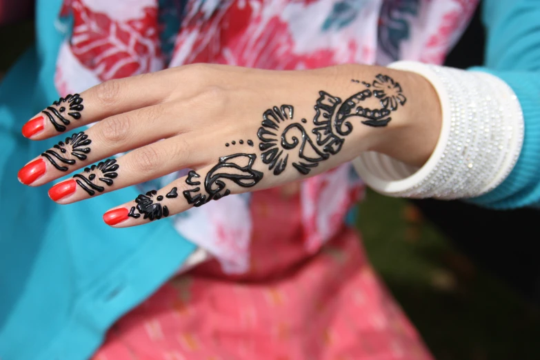 a woman's hand that has some black hennies on it