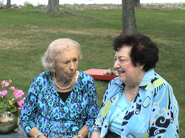 an old woman sitting with an older woman