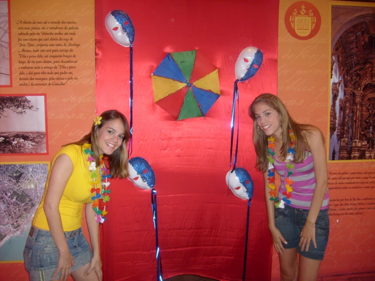 two s are posing in front of a display of toys