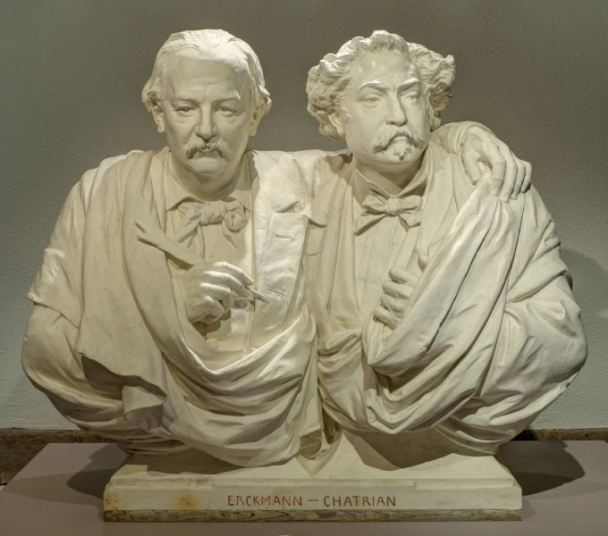 two statues in a museum each wearing a bow tie