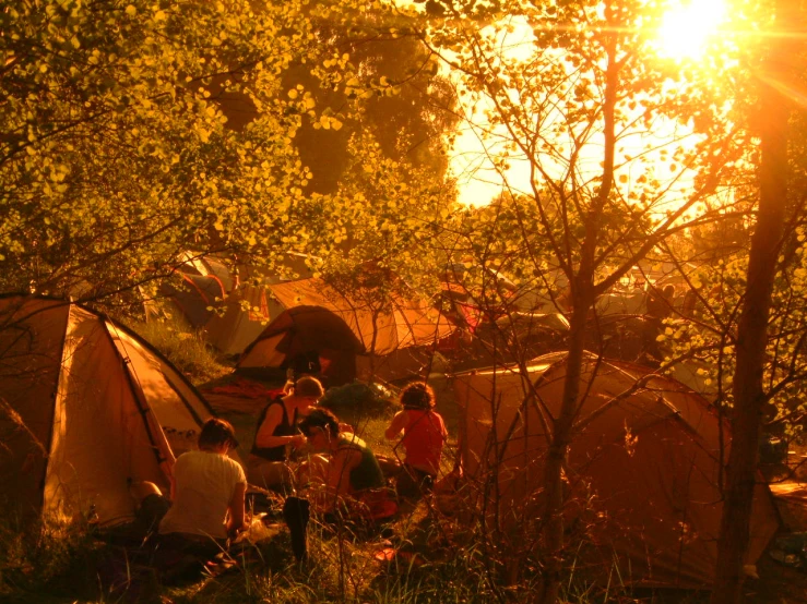 a group of people that are next to some tents