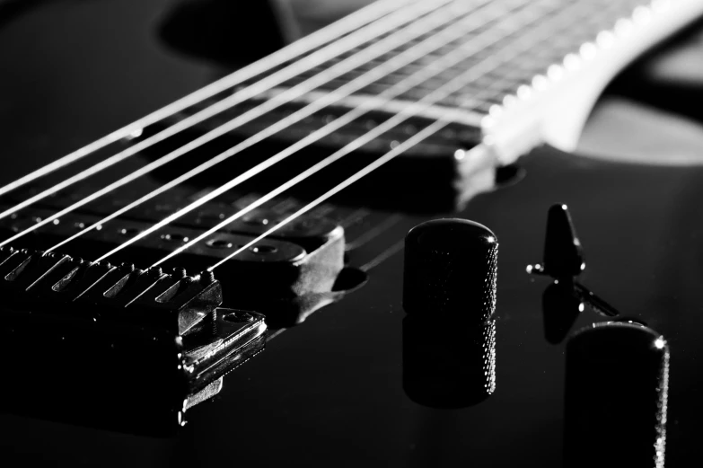 a closeup of a guitar neck, pickuper, and other accessories