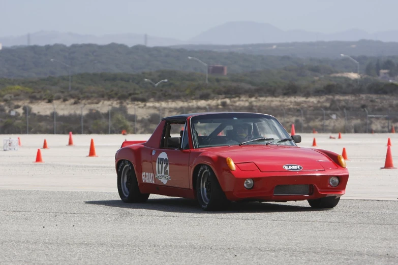 a red sports car with a flat windshield