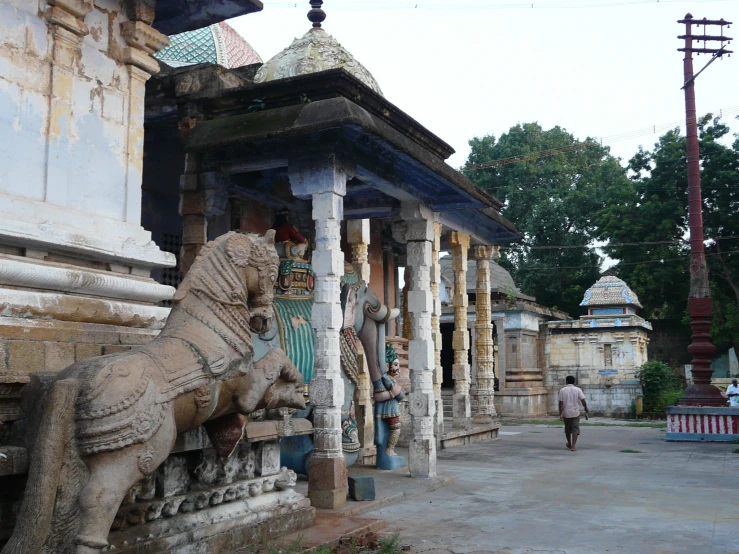 stone lions on pillars surrounding an old building