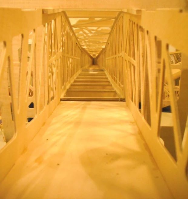 a wooden bridge with stairs that lead up to the top