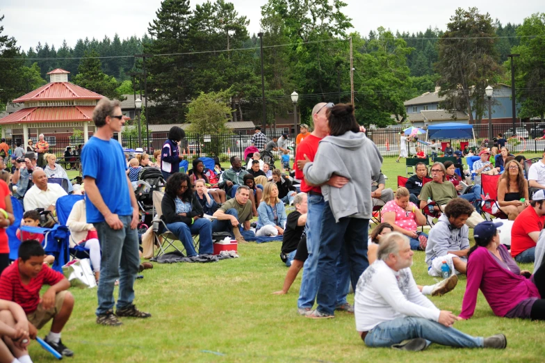 people are gathered in a park for a gathering