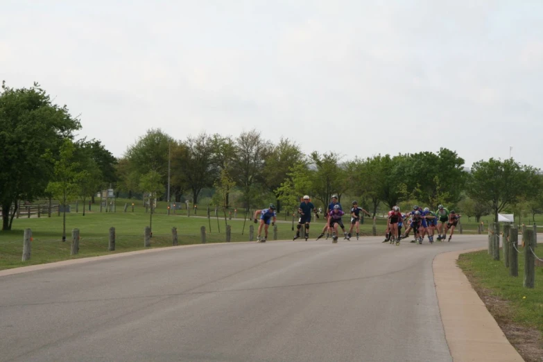 a group of people riding skateboards down a street