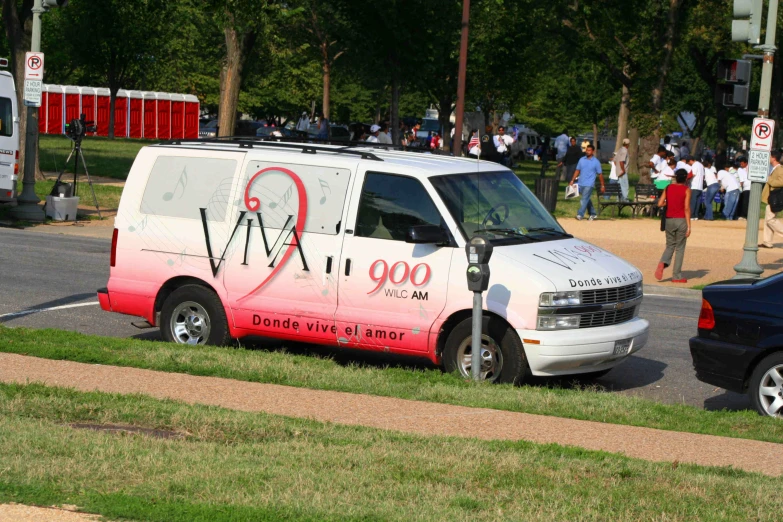 the pink and white van has a heart and is parked