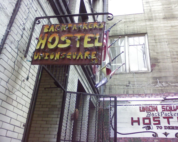 a large rusty sign mounted to the side of a building