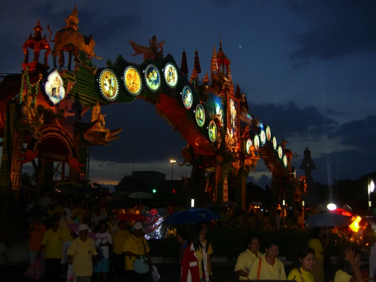 people gathered at a carnival with the colors changing