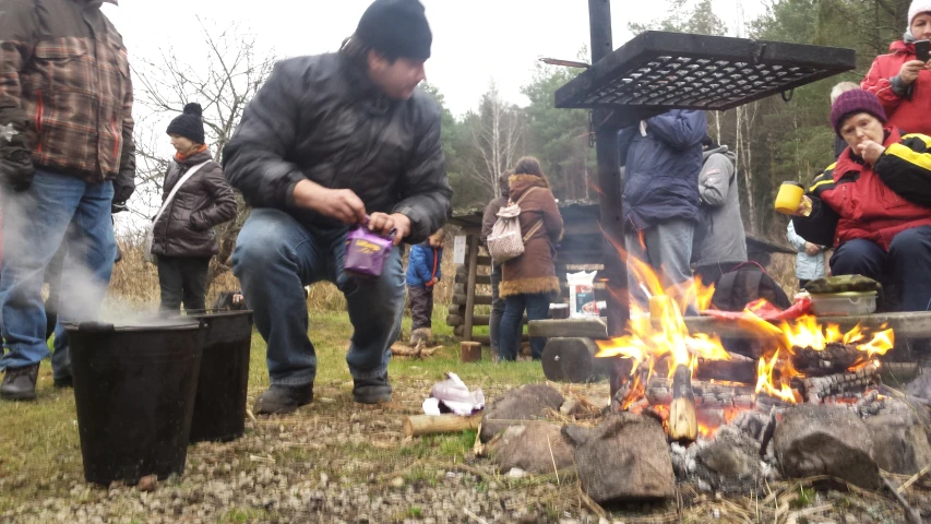 a group of people sitting around a fire