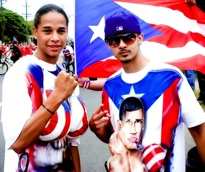 two people standing together near a flag holding up signs