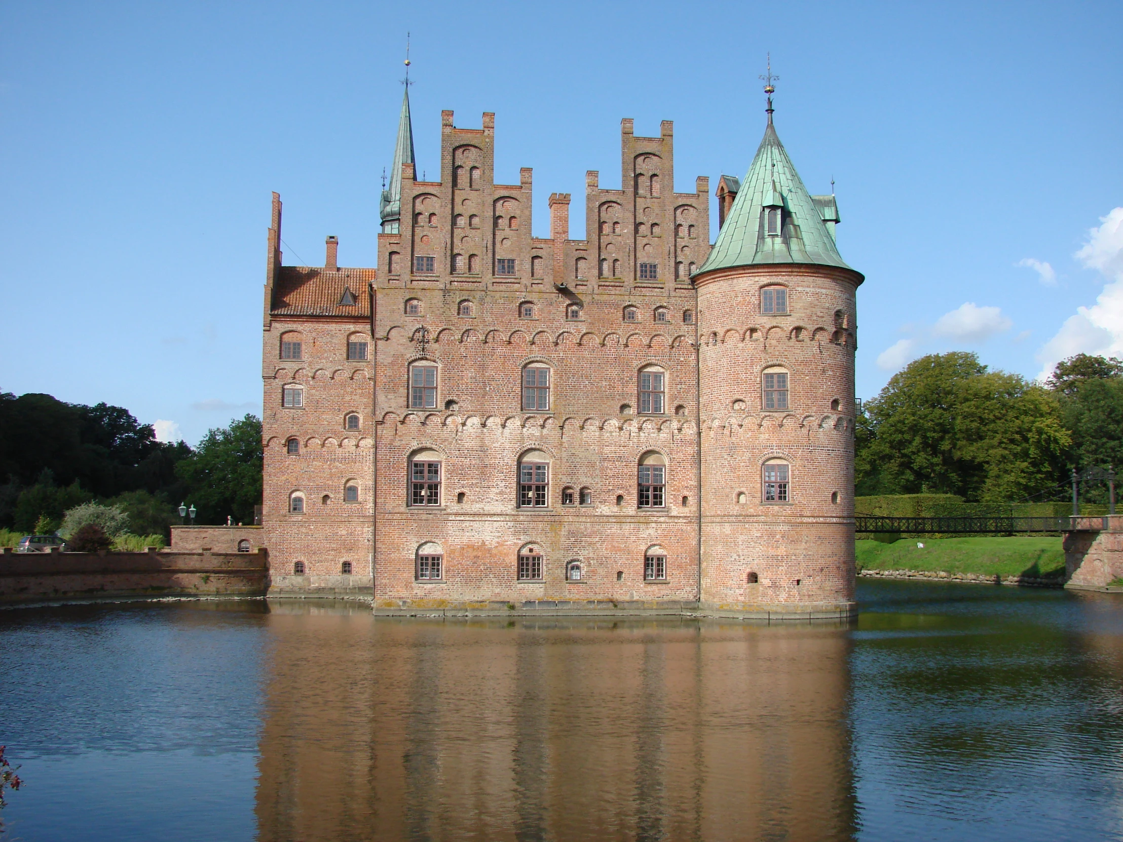 the large building is very tall by the water