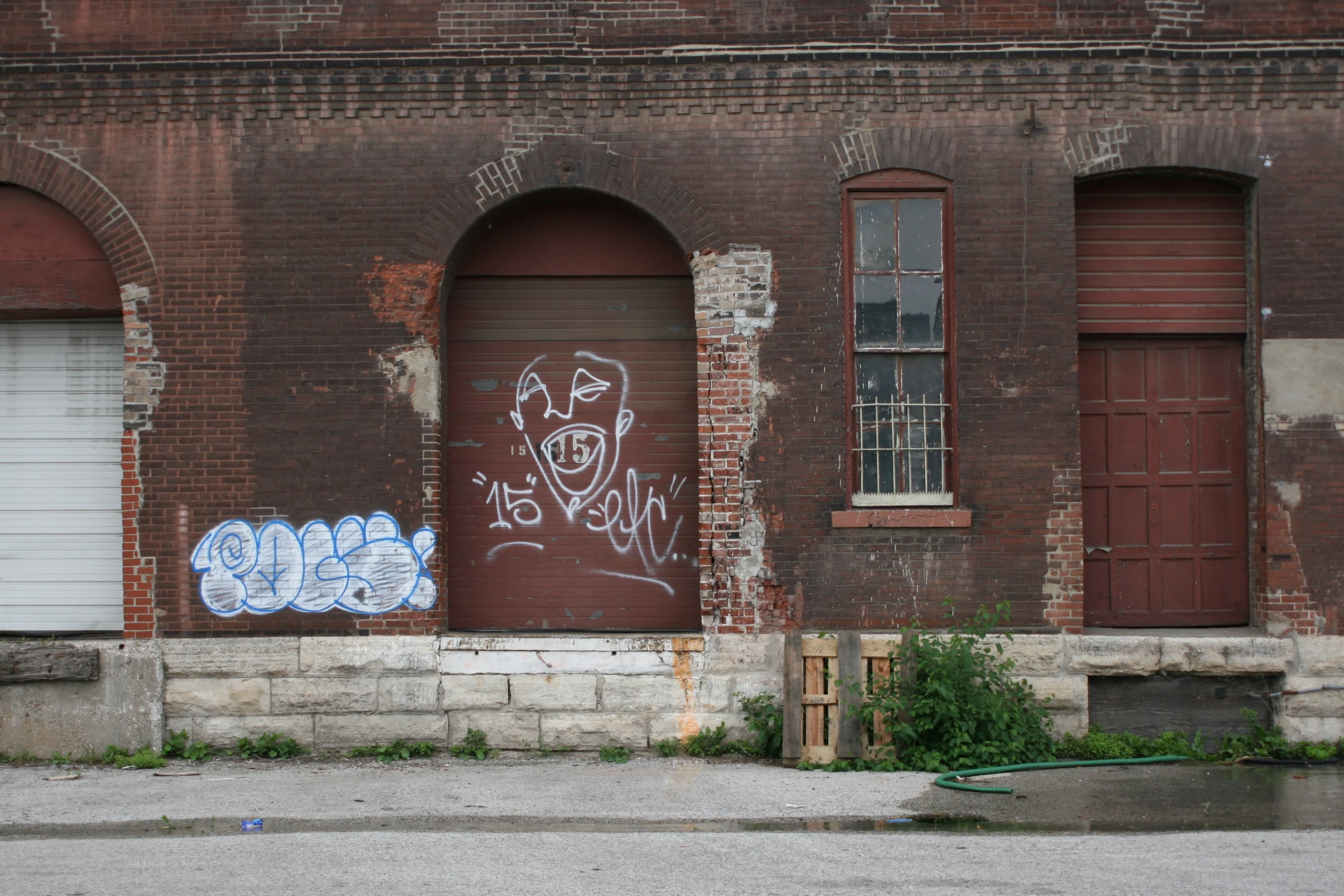 a building with graffiti on it next to a fire hydrant