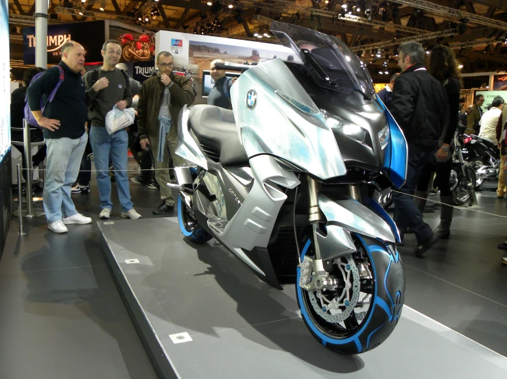 a silver and blue motorcycle is on display