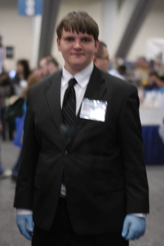 a man in a suit and mask is smiling for the camera