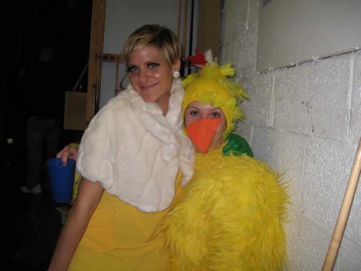 the girl is holding onto a stuffed chicken