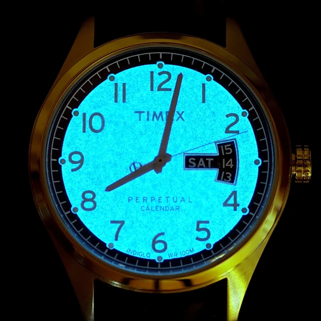 an illuminated gold watch with roman numerals and blue glow