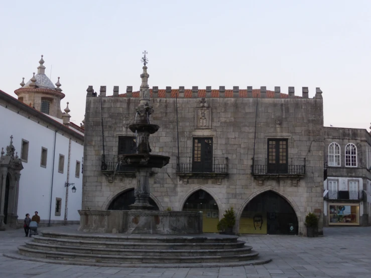 a very old building with a fountain on top