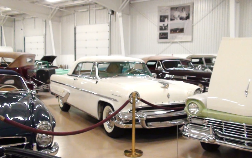 various model cars parked on a showroom floor