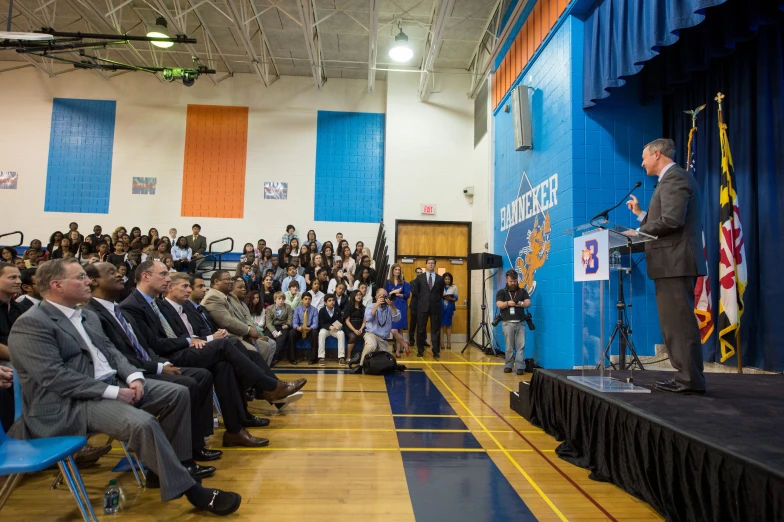 a man speaking in front of a group of people