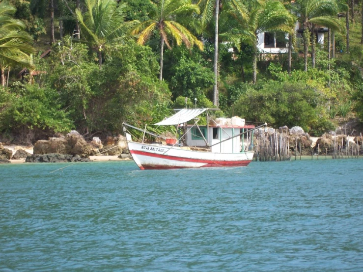 a boat sits out on the ocean near the shore