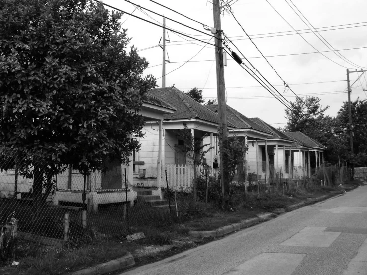 the street is dark and vacant, except for houses