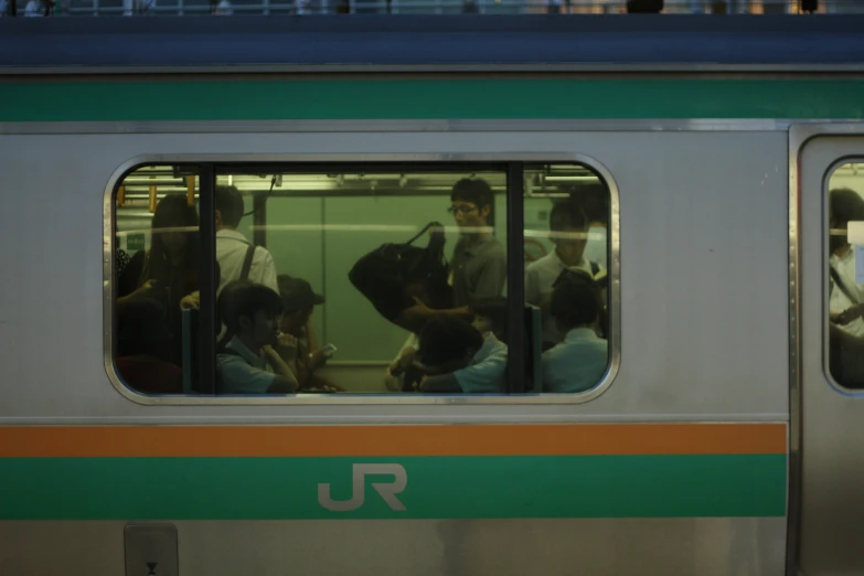 commuter train with passengers looking out the windows