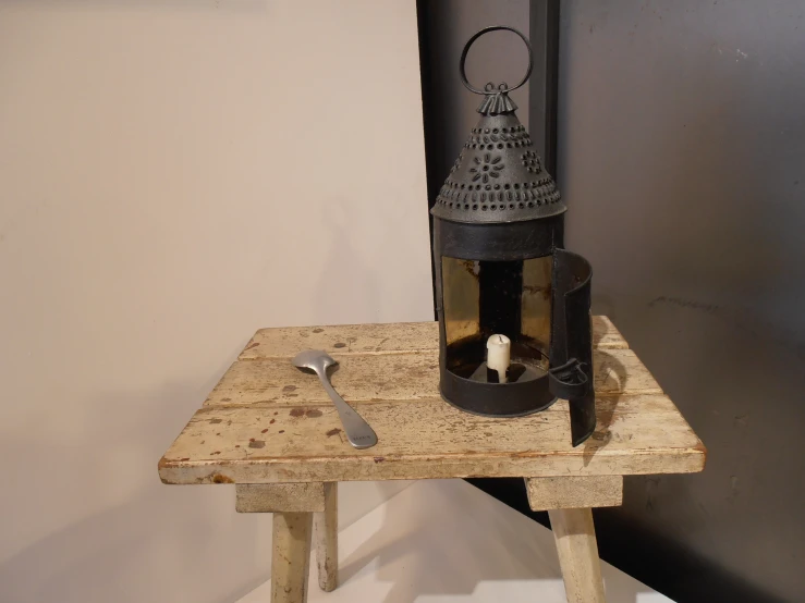 the inside of an old kitchen stove on a wooden stool