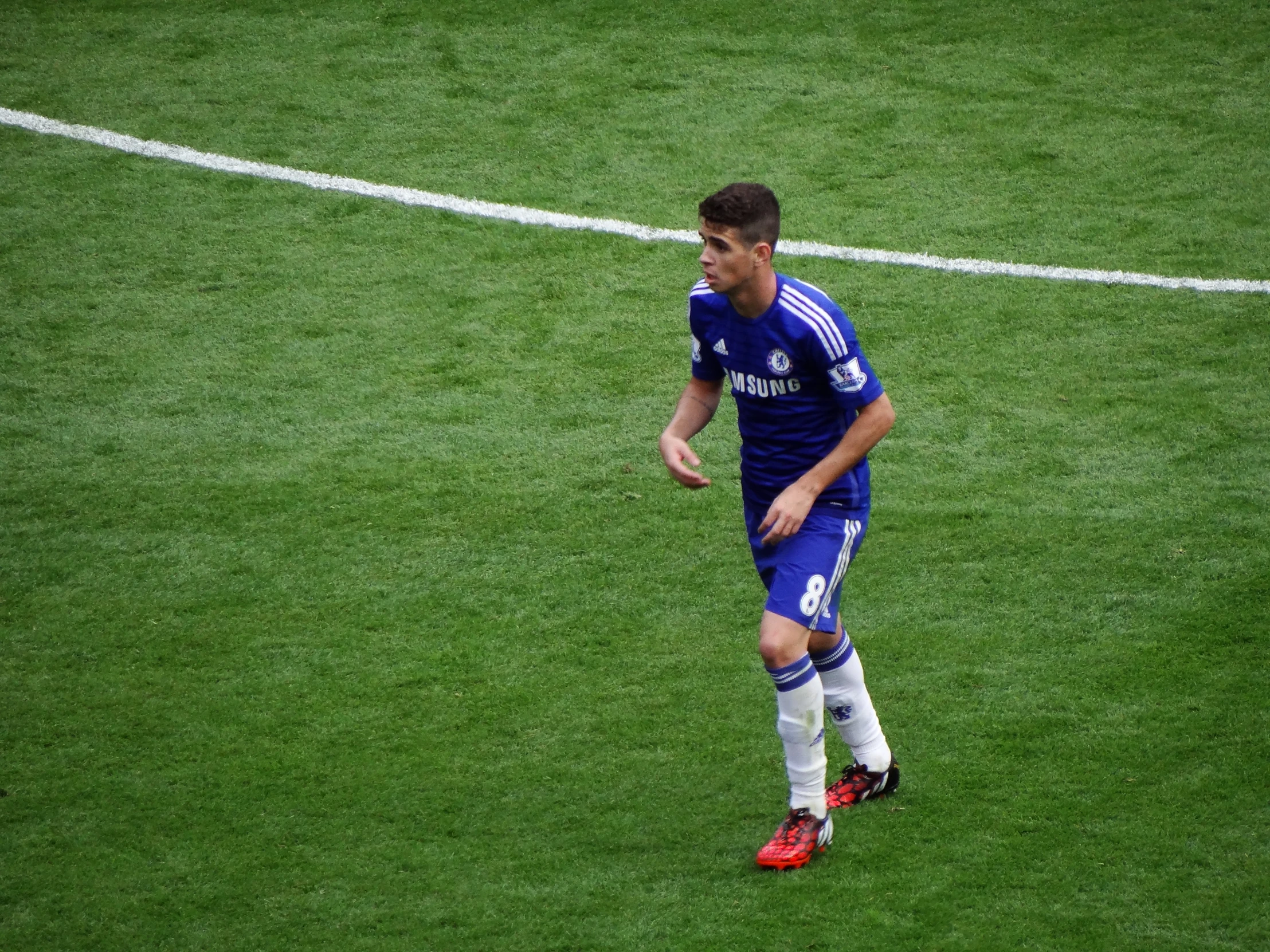 soccer player in blue uniform on field during match play