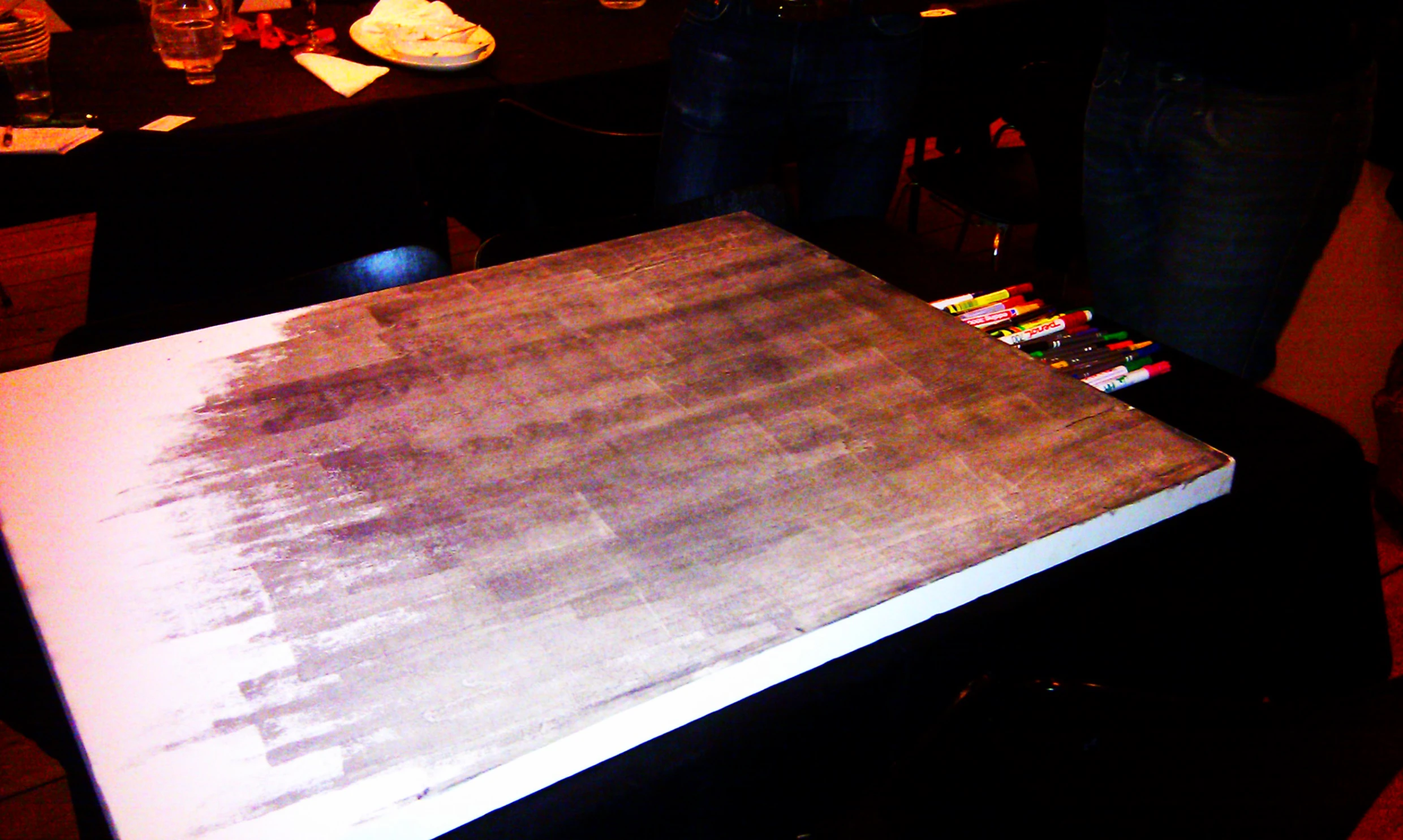 a large knife sitting on top of an open wooden  board