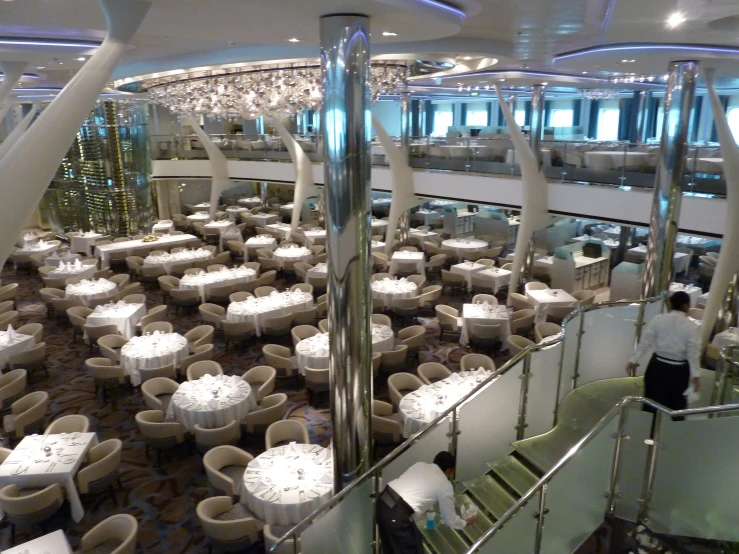 the large dining room is decorated with white linens