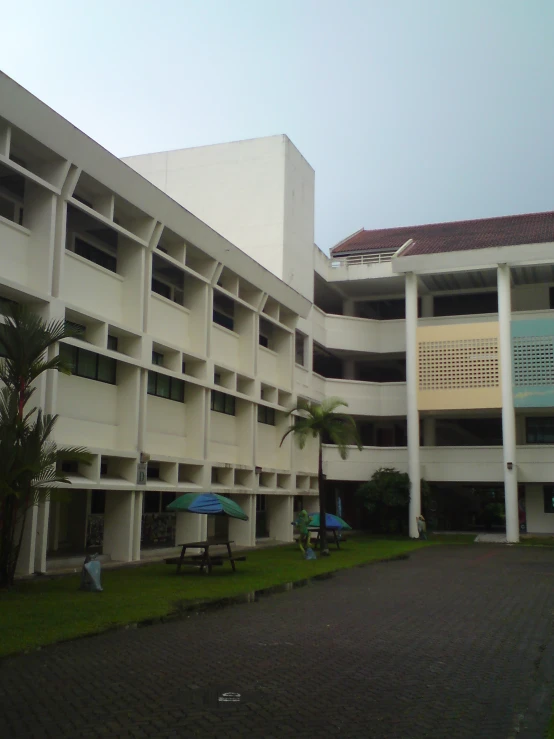 a tall building with balconies and palm trees