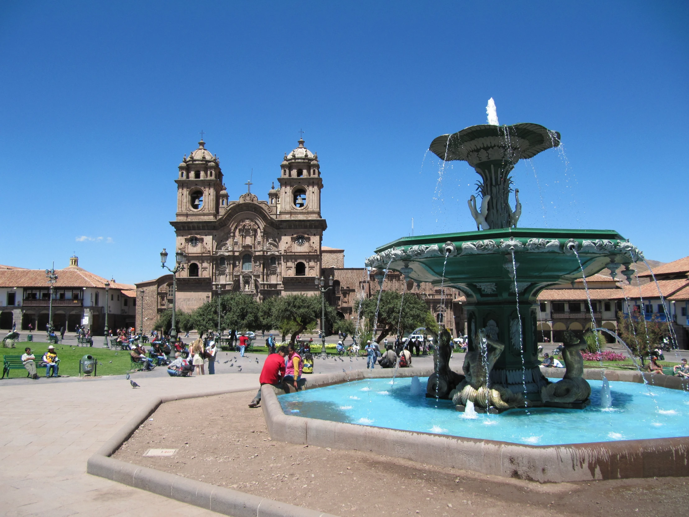 the fountain is very large and the people are all around it