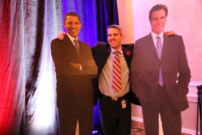 two men in suits and ties stand next to one another