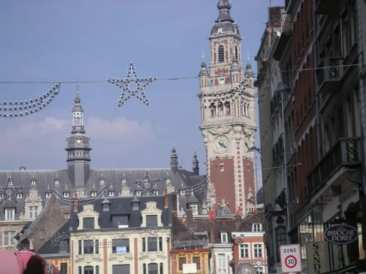 a group of buildings with buildings and christmas lights on top