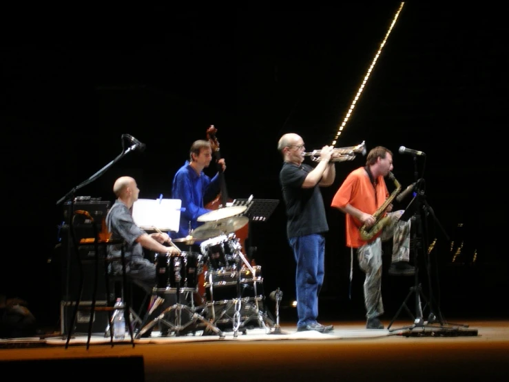 a band on stage playing musical instruments for the audience