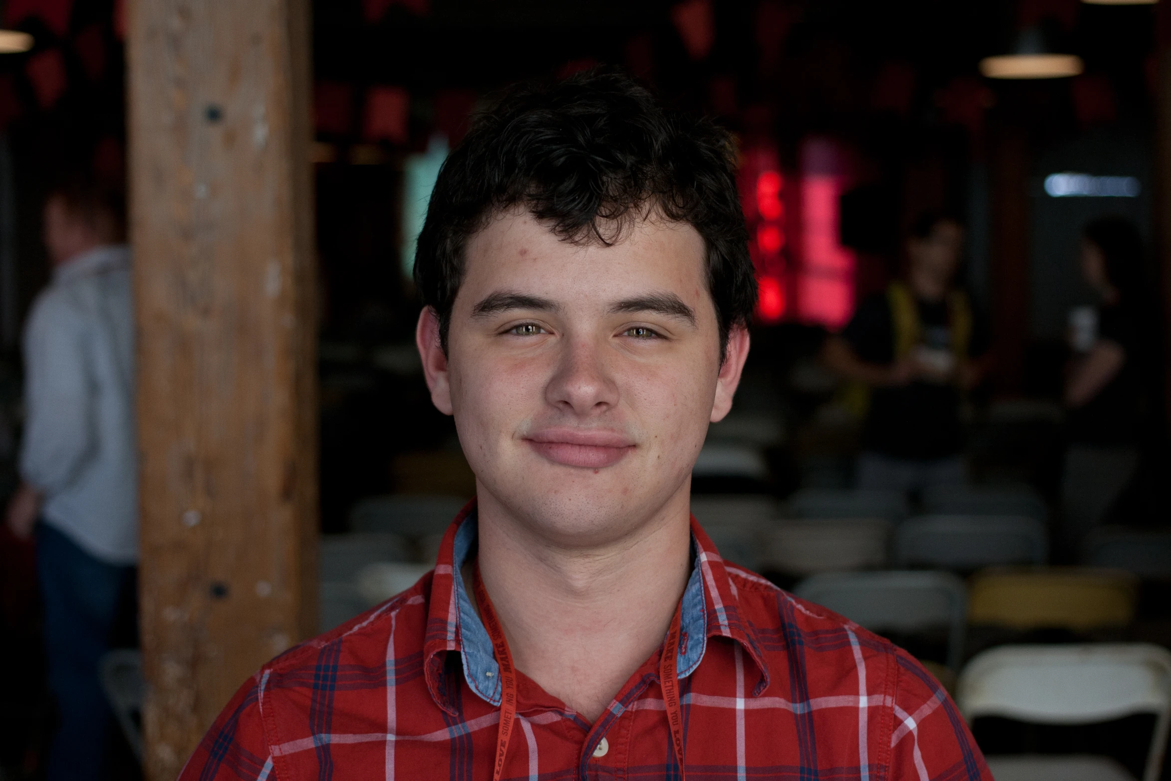 a man is standing in a restaurant with several tables