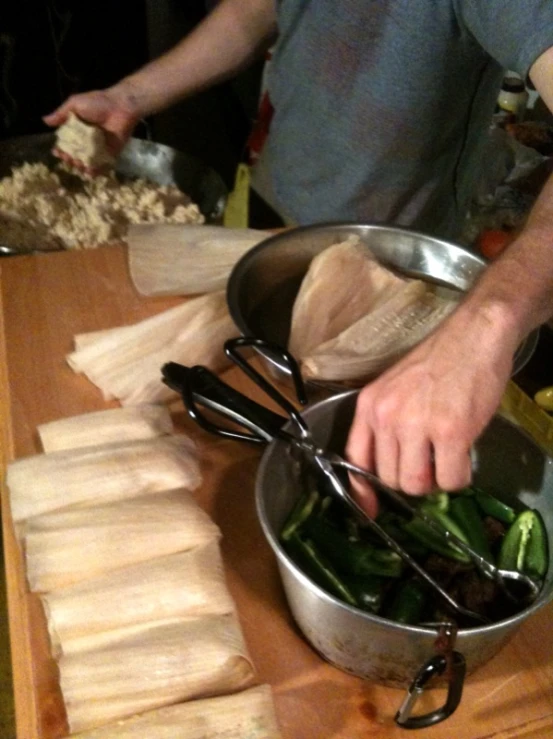 a man cuts up food on a  board