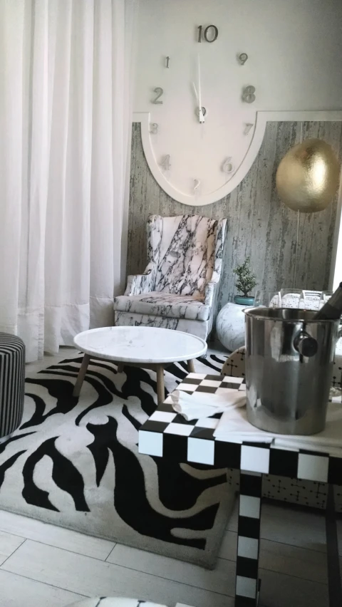 a modern living room with black and white rugs