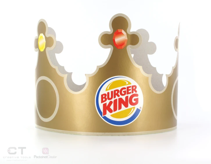 a golden burger king crown sitting on a white background