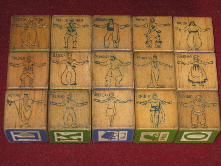 seven wooden box stamps with images of men in costume