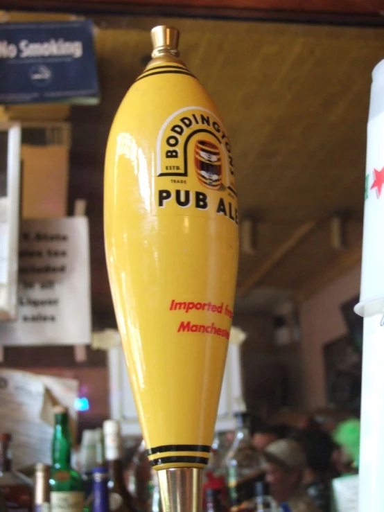 a yellow bottle with a silver top in a store