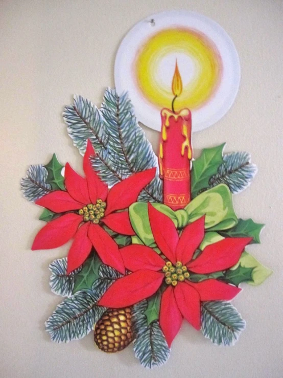 an image of a candle with holly and poinsetti