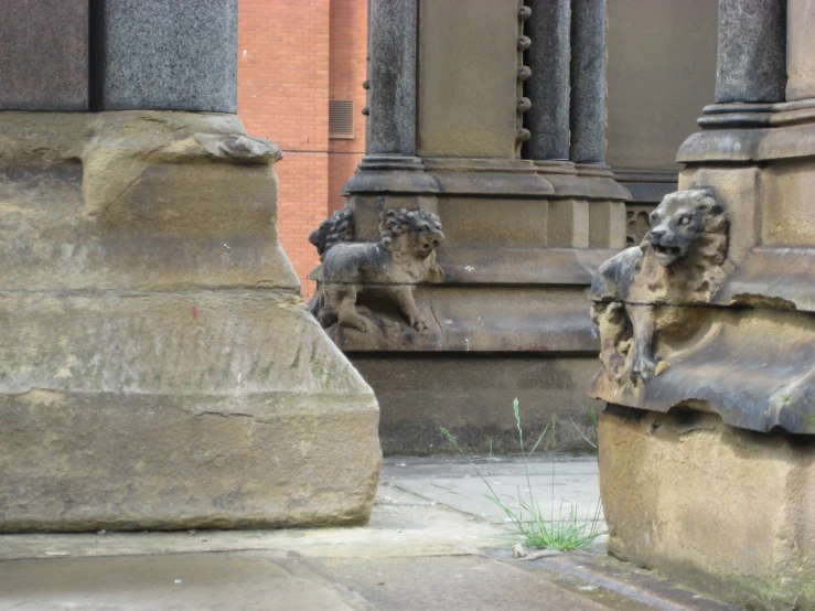 two sculptures next to each other near some stairs