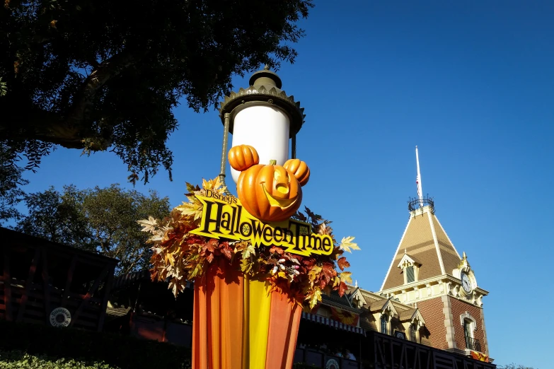 there is a statue made out of fake pumpkins and a banner that says happy halloween